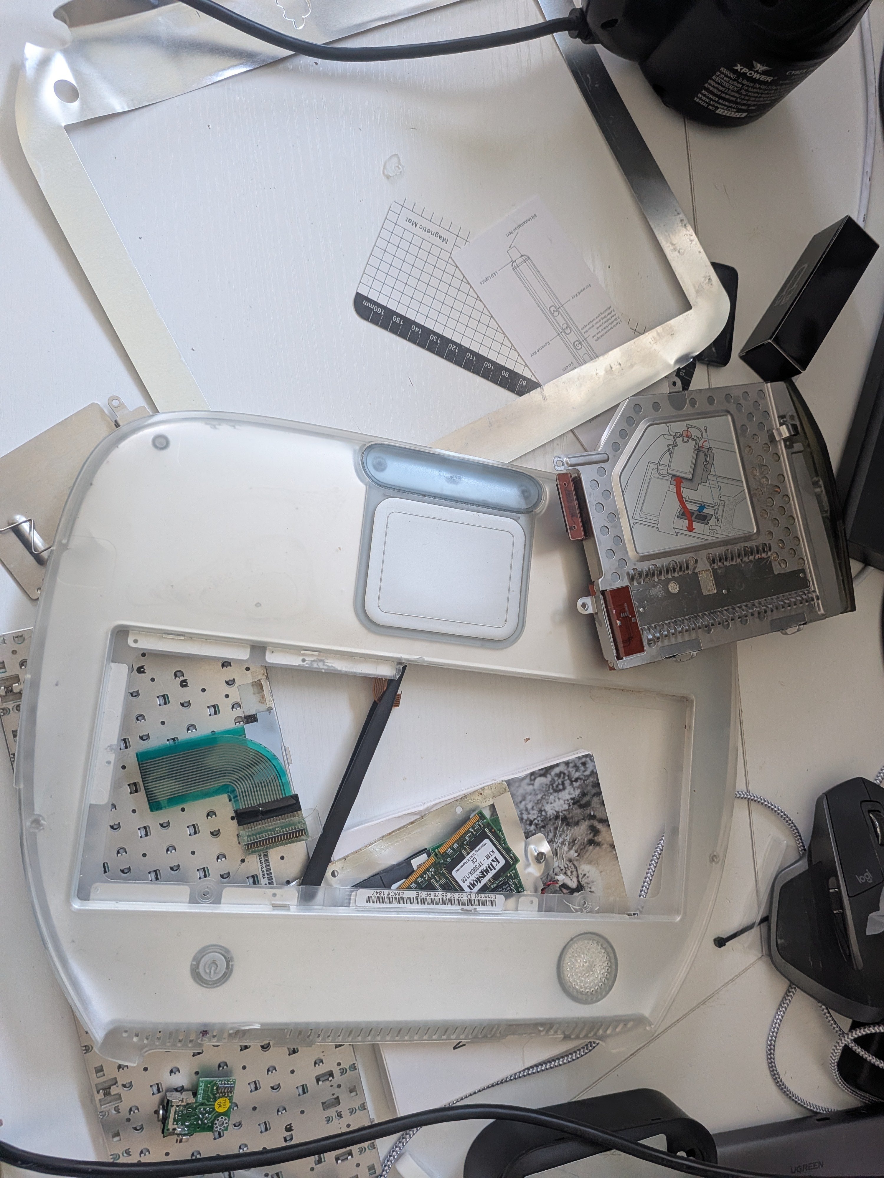iBook G3 Clamshell disassembled on workbench after isopropyl cleanup